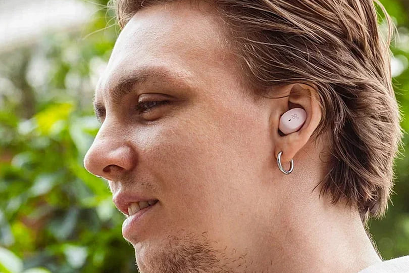 A man wearing AG earbuds