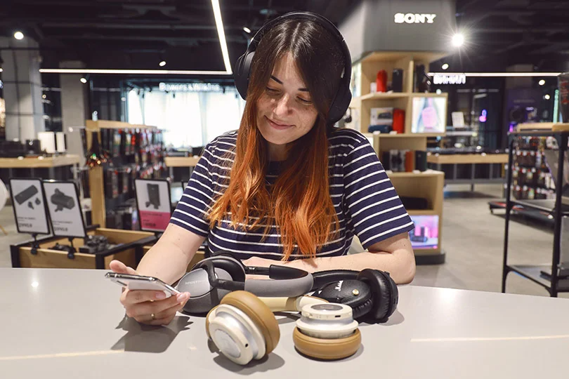 Woman tests different headphones