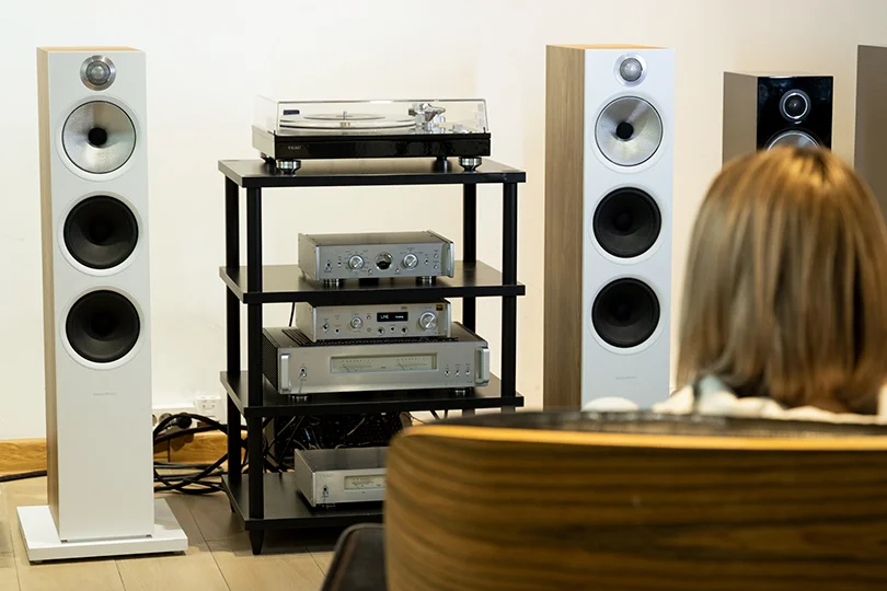 Woman Sitting in Front of a Home Audio Setup